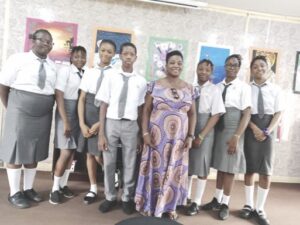 Oluchi Benedict, art teacher, Laureates College, flanked by some of the student exhibitors