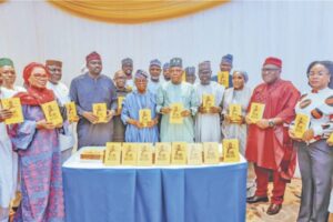 Vice President Shettima flanked by Mr Oyetola, the author, Omipidan and other dignitaries at the book presentation