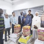 •Ahmed (middle) flanked by refugees