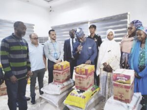 •Ahmed (middle) flanked by refugees