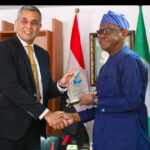 FCT Minister Nyesom Wike (r) presents a gift to the visiting Egyptian Ambassador to Nigeria, Mohammed Fouad in his office on Thursday