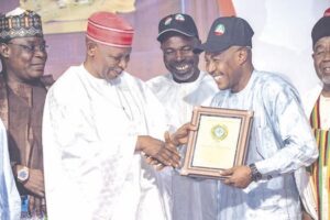 Gov. Yusuf presenting award to a recipient