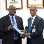 L-R: Permanent Secretary, Ministry of Police Affairs, Dr. Anuma Ogbonnaya Nila receiving hand over note from the Director overseeing the office of the Permanent Secretary, Mr. Okehie Isaac Tochukwu during a meeting with the Management and staff of the Ministry on his assumption of duty at the Ministry of Police Affairs Headquarters in Abuja