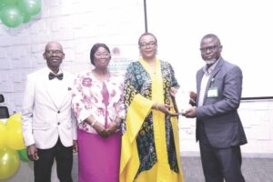 L-R- Olaseni; wife; Lawanson and Badmus, presenting plaque to Lawanson