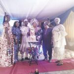 Mr. and Mrs. Adebote (middle) with friends and family members cutting her 60th birthday cake