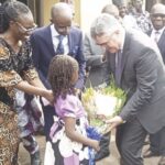 Nfor Raphaella Esther present flower bouquet to Kohler. Prof. Tayo and others watch