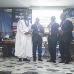 Pastor Samuel (second right) receiving his award from organisers