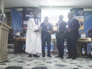 Pastor Samuel (second right) receiving his award from organisers