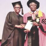 Prof. Odukoya (right) presenting a copy of his lecture to acting VC, Prof. Oboh