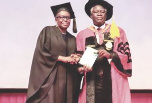 Prof. Odukoya (right) presenting a copy of his lecture to acting VC, Prof. Oboh
