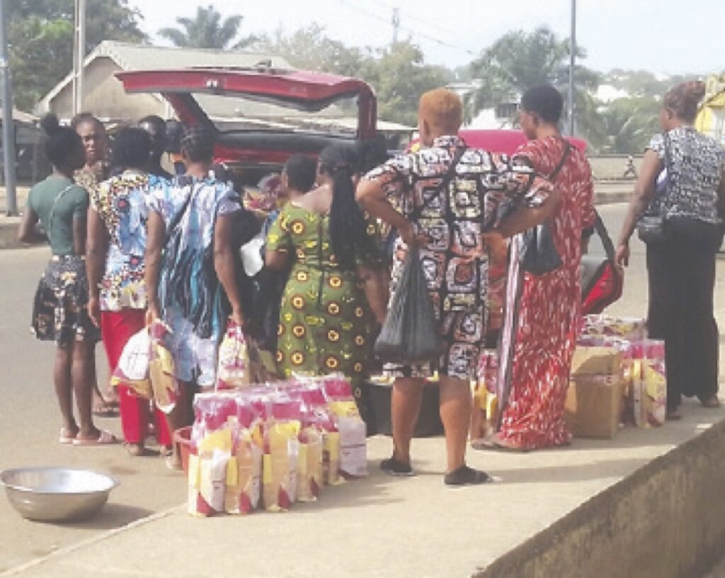Retailers loading their wares in a vehicle.