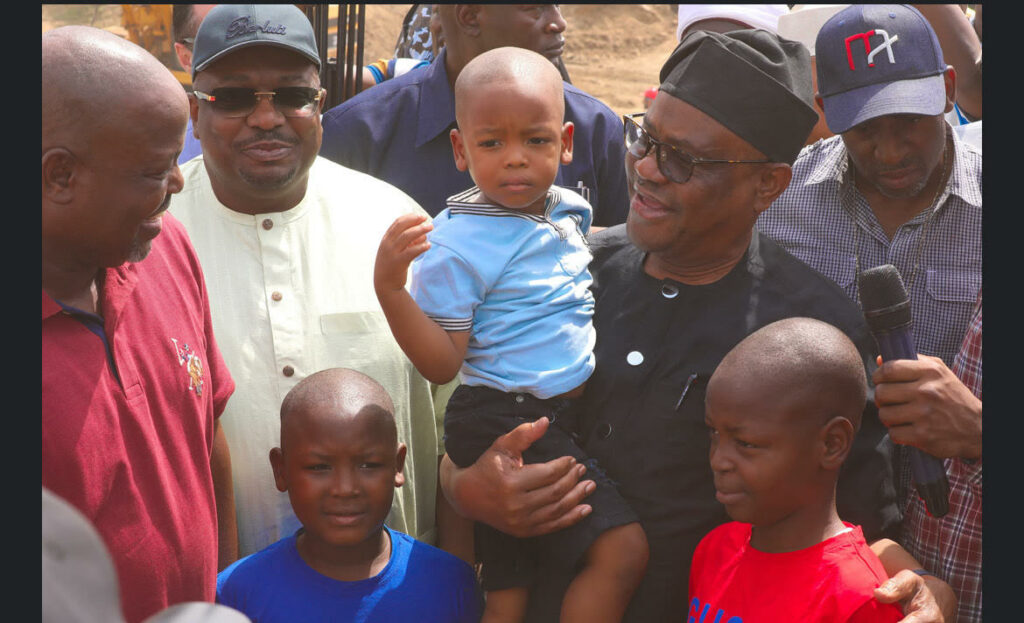 FCT Minister Nyesom Wike with Godswill, Godspower, and Godstime, children of the Chairman, Kwali Area Council, Danladii Chiya (1st left) and Senator Philip Aduda (2nd left) during the Minister’s project inspection visit to Kwali on Saturday, February 15, 2025