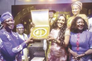 Edu receiving the award, with Prof. Obi (right) and others