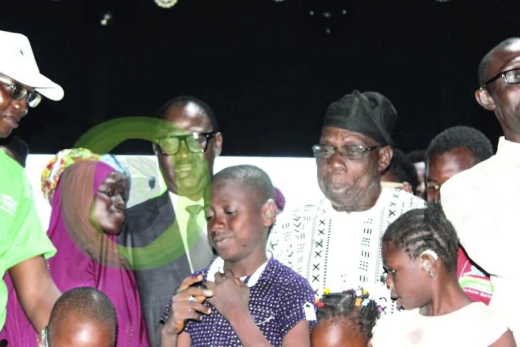 Obasanjo with beneficiaries of the free hearing aids