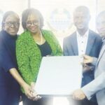 Officials of Interswitch presenting IT equipment to Prof. Ogunsola