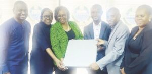 Officials of Interswitch presenting IT equipment to Prof. Ogunsola