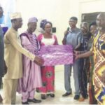 Prof. Nasir (4th right) presenting gift to Prof. Egbowon with Prof. Obayori (left) and Dr. Idris (2nd left).