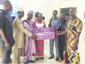Prof. Nasir (4th right) presenting gift to Prof. Egbowon with Prof. Obayori (left) and Dr. Idris (2nd left).