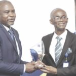 Prof. Tayo (left) presenting plaque to Senator Salisu