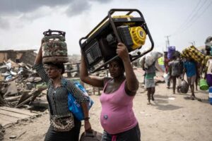 Residents carry their belongings after the demolition of a Lagos suburb, 2025. Olympia De Maismont/AFP via Getty Images