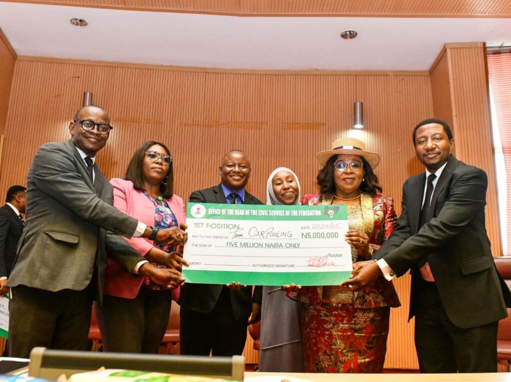 Head of the Civil Service of the Federation (HCSF), Didi Walson-Jack, poses with the Carpooling Team, overall winners of the 5th Annual Federal Public Service Innovation Competition, holding their N5 million prize cheque. The award ceremony recognized their innovative solution among over 155 entries, reinforcing the government’s commitment to fostering innovation in the civil service