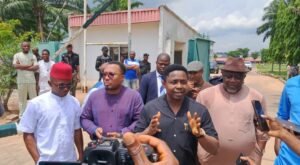 Deputy-Speaker-of-the-Abia-State-House-of-Assembly-Rt.-Hon-Augustin-Okezie-addressing-parents-protesting-the-high-school-fees-charged-at-the-Government-College-Umuahia