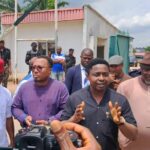 Deputy Speaker of the Abia State House of Assembly, Rt. Hon Augustin Okezie addressing parents protesting the high school fees charged at the Government College, Umuahia