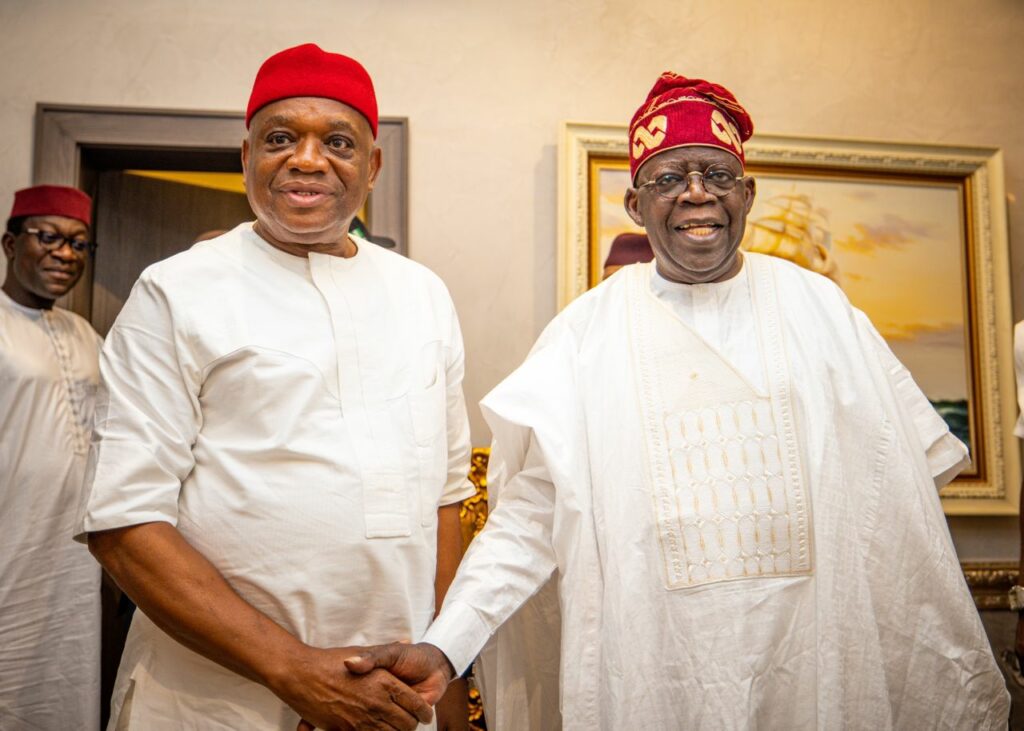 Senator Orji Uzor Kalu (left) and President Bola Tinubu (right) shake hands