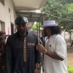 Jude Okoye being led by brother Paul Okoye