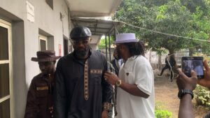 Jude Okoye being led by brother Paul Okoye