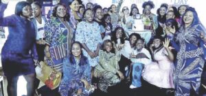 Some of the women who attended the event pose for photo during the cutting of the cake to mark the day