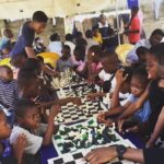 TUNDE-ONAKOYA-PLAYING-CHESS-WITH-CHILDREN