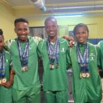 Team-Nigeria-Weightlifters-Poses-With-Their-Medals