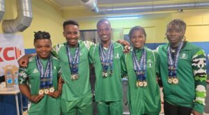 Team-Nigeria-Weightlifters-Poses-With-Their-Medals
