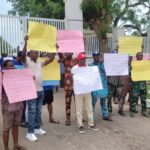 Residents of Osuke-Ota Community with placards at the entrance to the Governor’s Office, Oke Mosan, Abeokuta, during a protest against notorious land grabbers
