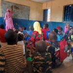 Pupils sitting on the bare floor in a public primary school in Kogi