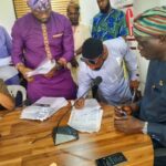 Commissioner for Lands Akin-funmilayo Williams (right), a Claimant (middle), during the cheque distribution on Thursday, April 10, 2025