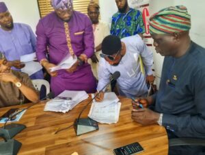 Commissioner for Lands Akin-funmilayo Williams (right), a Claimant (middle), during the cheque distribution on Thursday, April 10, 2025