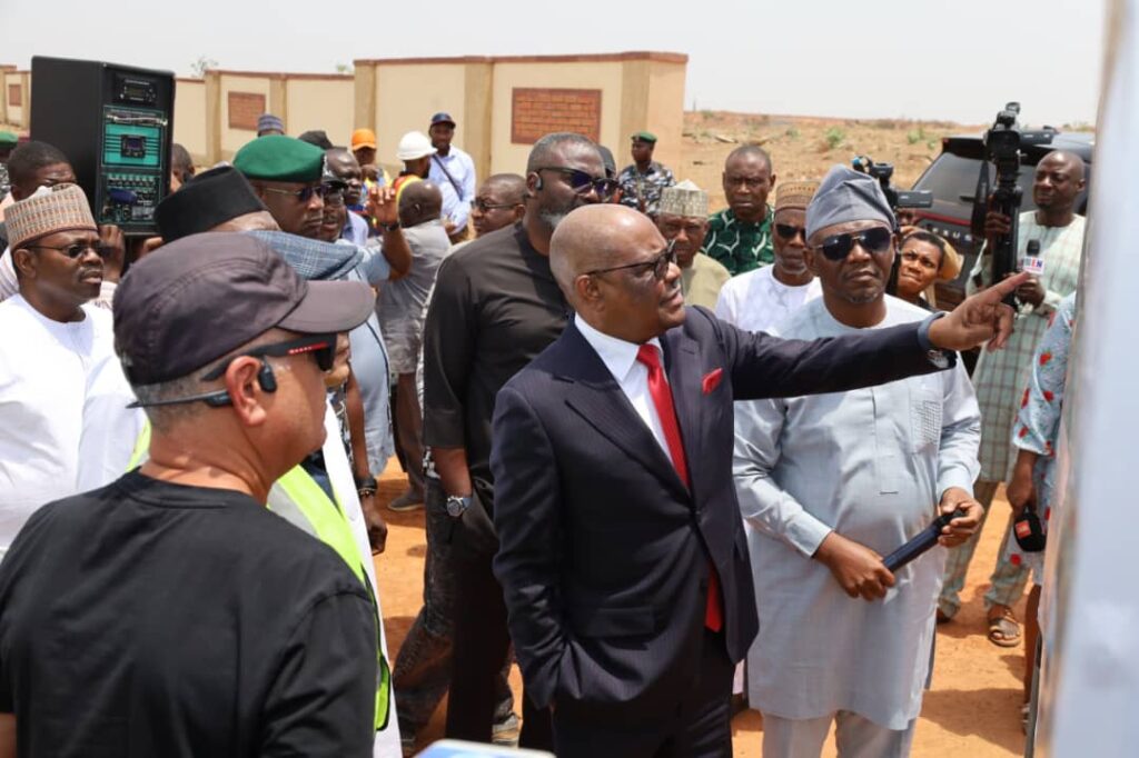 FCT Minister Nyesome Wike examining the plans for the construction of the road into the EFCC Academy in Giri District on Friday