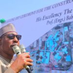 Gov Zulum addressing contractors and residents at the flag of flyover at Post Office Maiduguri