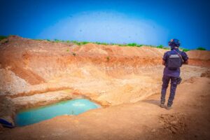 Mining Marshal in Zamfara looks at a shallow pool