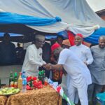 Enugu State APC Chairman, Chief Ugochukwu Agballah (L) receiving Sunday Umeha (R) LP Rep Member, who officially defected to APC during a rally at Ibagwa-Aka in Igboeze South LGA, at the weekend