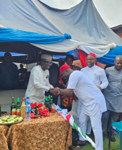 Enugu State APC Chairman, Chief Ugochukwu Agballah (L) receiving Sunday Umeha (R) LP Rep Member, who officially defected to APC during a rally at Ibagwa-Aka in Igboeze South LGA, at the weekend