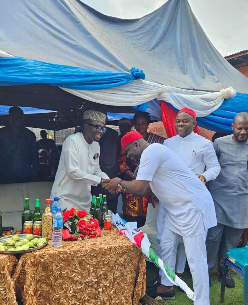 Enugu State APC Chairman, Chief Ugochukwu Agballah (L) receiving Sunday Umeha (R) LP Rep Member, who officially defected to APC during a rally at Ibagwa-Aka in Igboeze South LGA, at the weekend