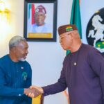Akwa Ibom governor pastor Umo Eno, National Chairman of NIPR Neliaku in a handshake at Govt House, Uyo