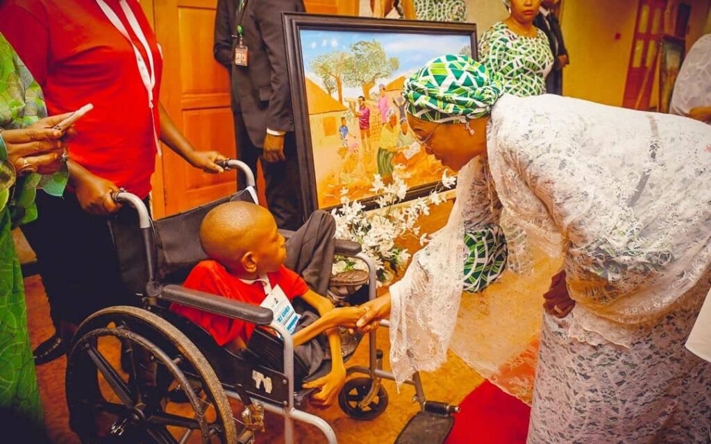 First Lady of Nigeria, Oluremi Tinubu with a young artist, Awelewa Eniola (a special needs child) after presenting her with his painting at the Launch of the special Adolescent Girls Initiative for Learning & Development, AGILE Additional Financing to States and AGILE Games Award Ceremony held at the State House, Abuja on Tuesday, May 27, 2025