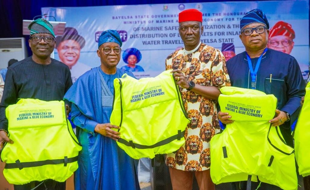 Minister of Marine and Blue Economy Adegboyega Oyetola (second left) led the official distribution of 3,500 life jackets to water transport users