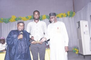 Prof. Afolabi, Etudaye and Dr. Abdul presenting plaque to Etudaye