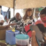 Team members dishing food for the people