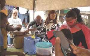 Team members dishing food for the people